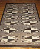 Navajo hand spun natural wool rug with waterbeetle and feather motifs